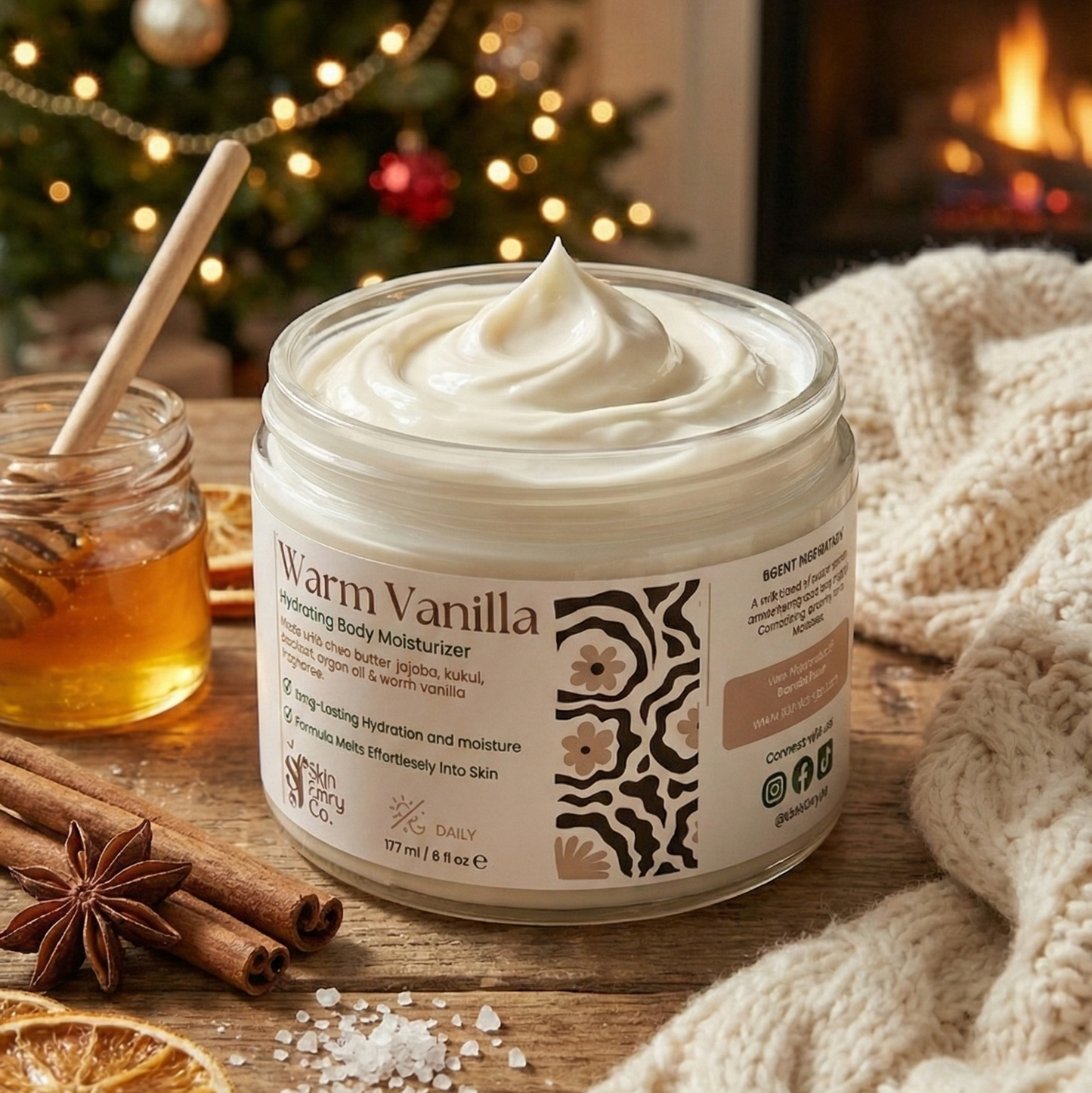 Jar of warm vanilla body moisturizer on a wooden surface with Christmas decorations in the background.