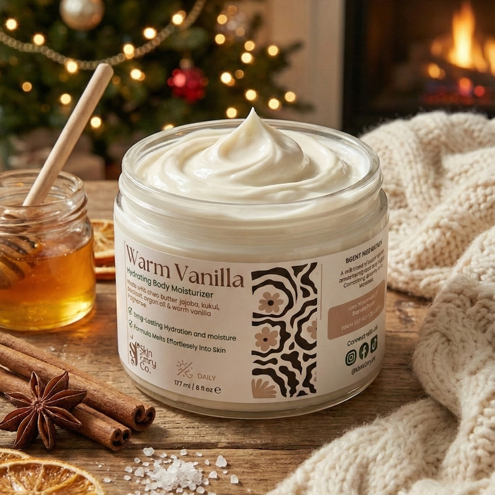 Jar of warm vanilla body moisturizer on a wooden surface with Christmas decorations in the background.